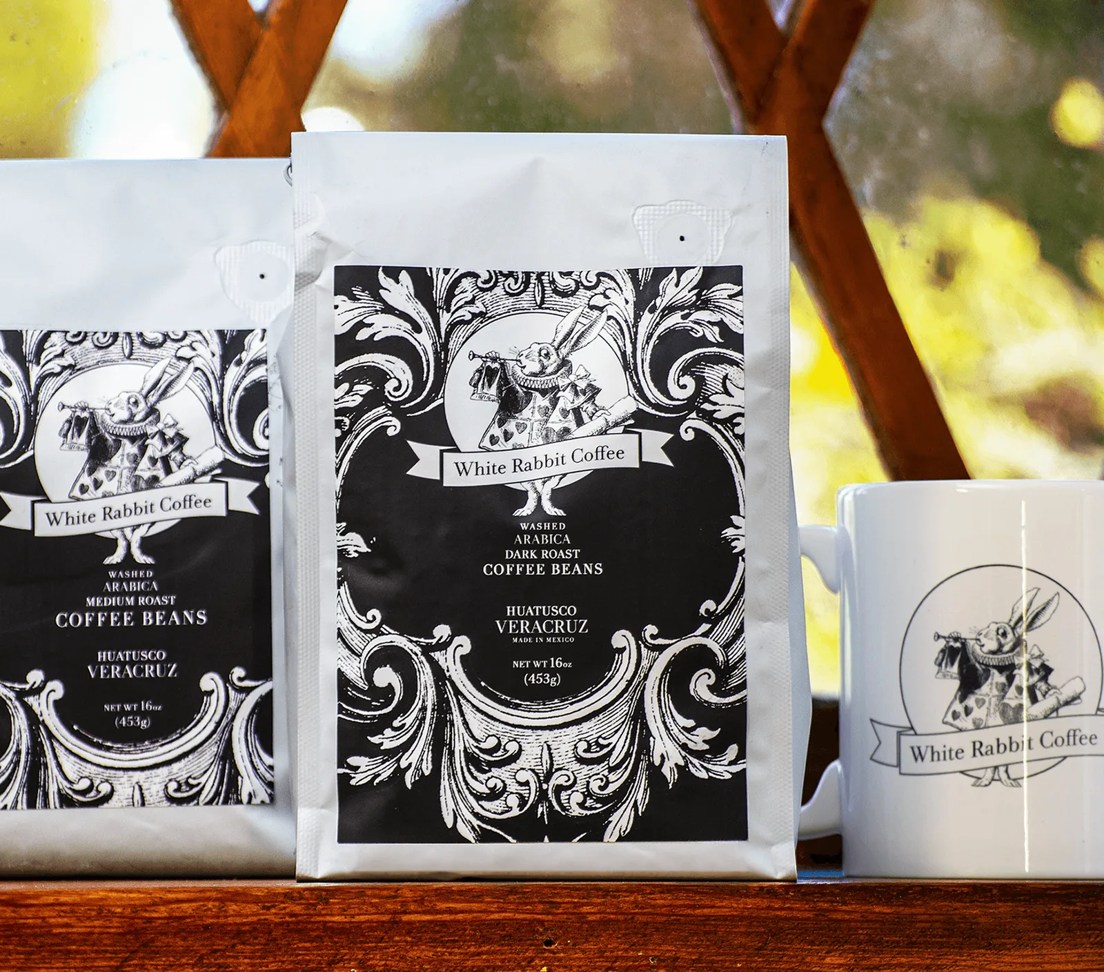 White Rabbit Coffee bags and mug on a wooden table